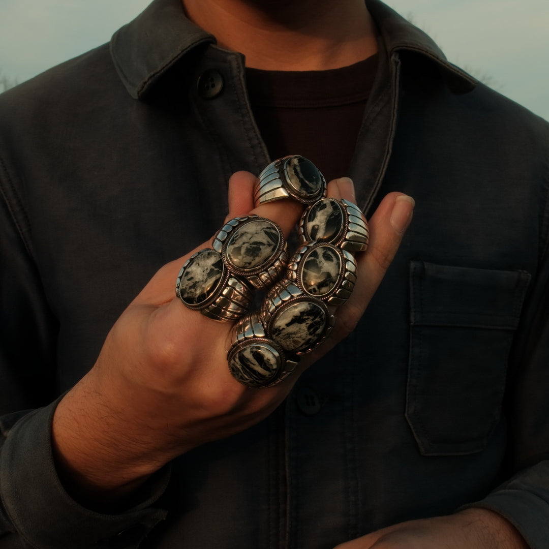 White Buffalo stone temple rings in sterling silver — stark white with a black matrix, from the single Nevada source.