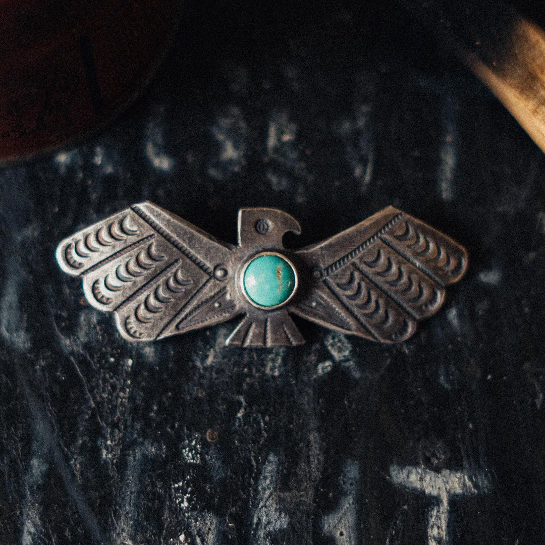 A one-of-a-kind sterling silver thunderbird pin set with turquoise, in the traditional Fred Harvey-era Southwest style.