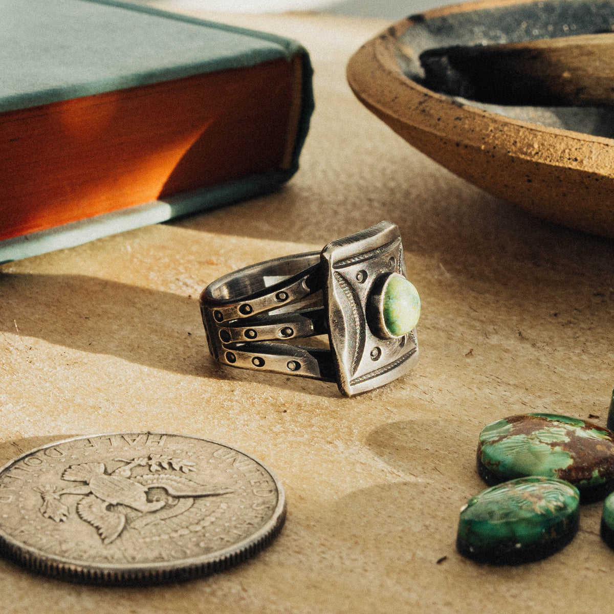 A hand-wrought sterling silver shield ring set with an oval Sonoran Gold turquoise stone, its soft green face touched with golden matrix, set in a smooth straight bezel — view 2