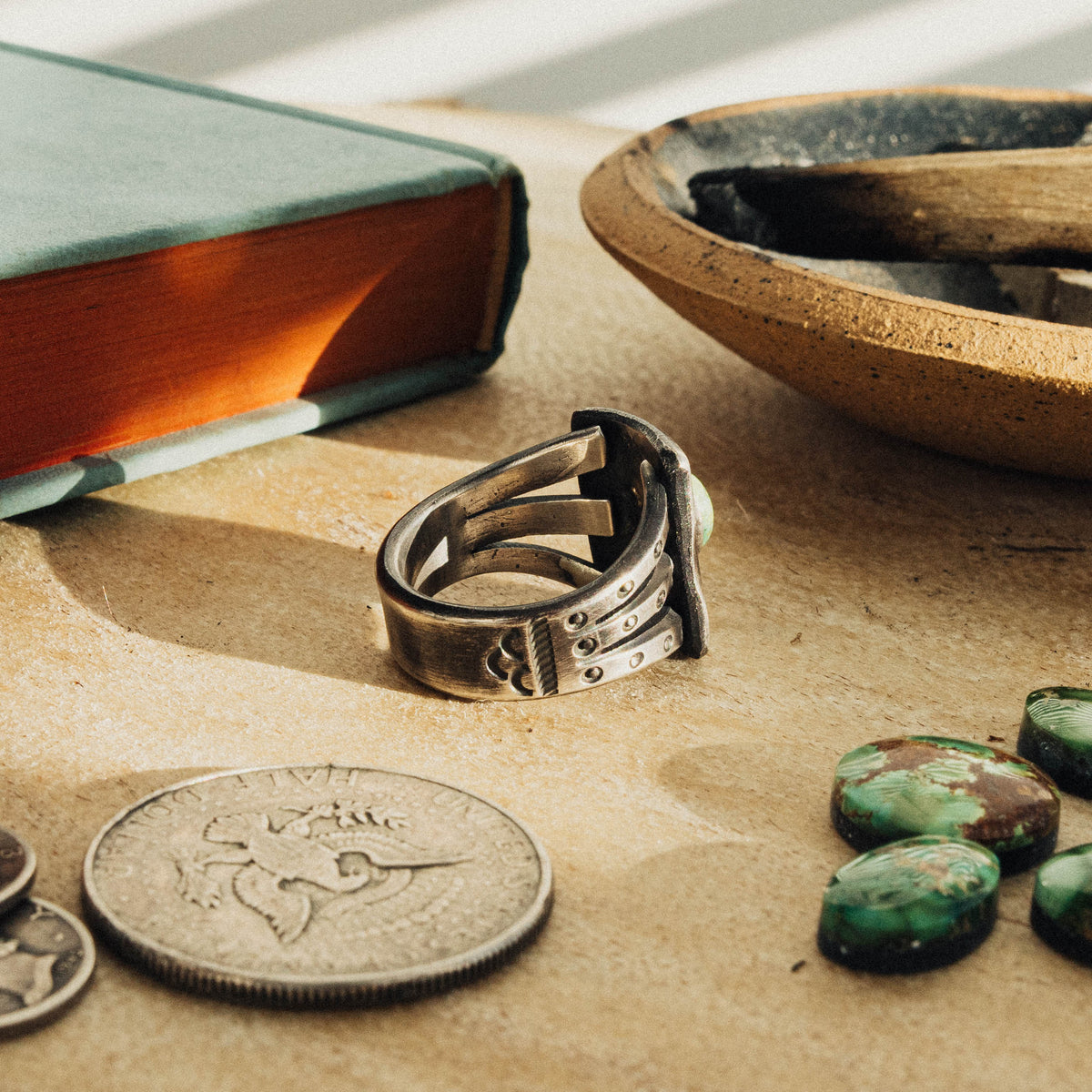 A hand-wrought sterling silver shield ring set with an oval Sonoran Gold turquoise stone, its soft green face touched with golden matrix, set in a smooth straight bezel — view 3