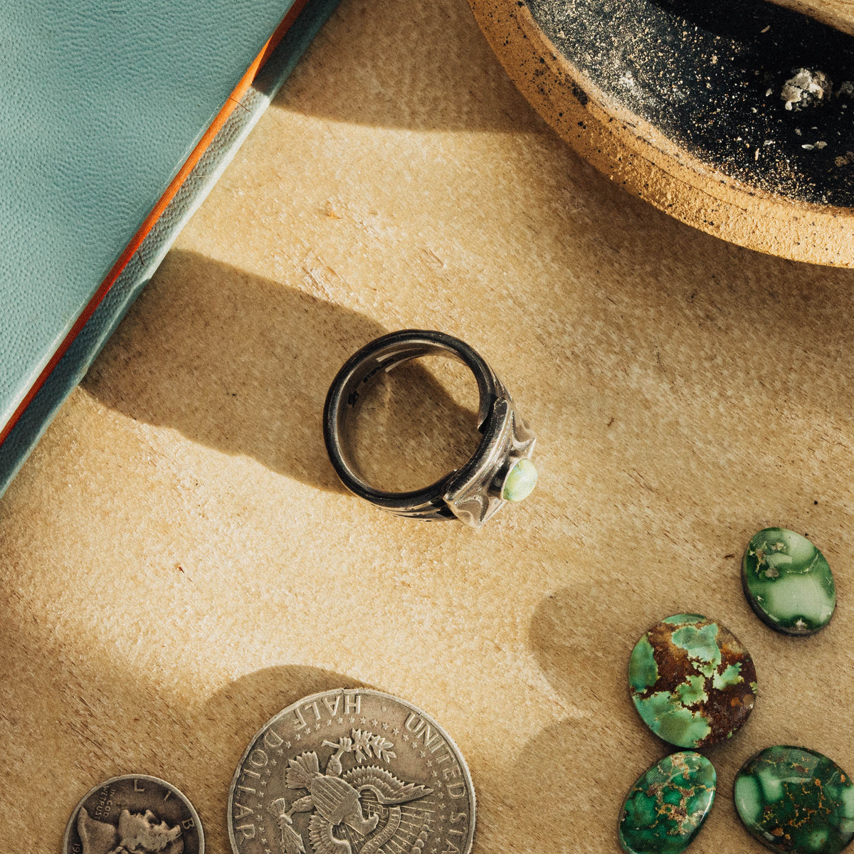 A hand-wrought sterling silver shield ring set with an oval Sonoran Gold turquoise stone, its soft green face touched with golden matrix, set in a smooth straight bezel — view 4