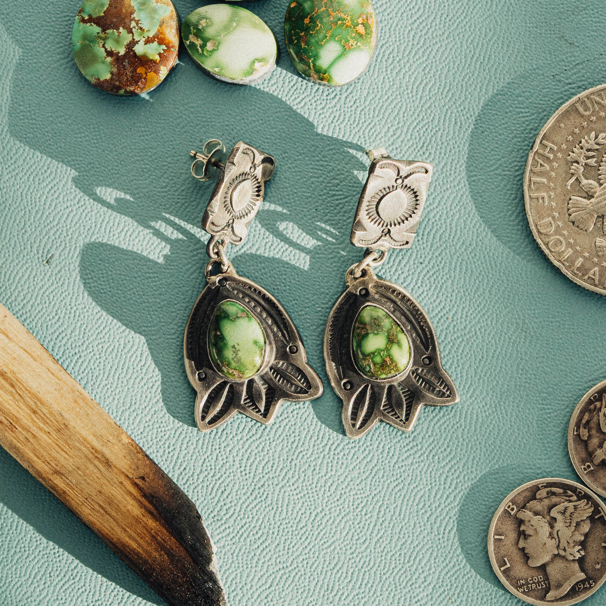 A pair of hand-wrought sterling silver two-tier drop earrings featuring Sonoran Gold turquoise, each stone a bright lime-green face veined with golden matrix