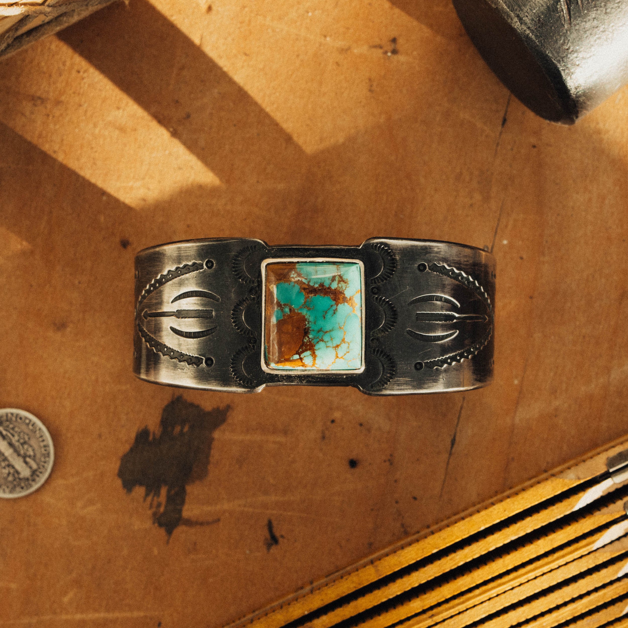 A one-of-a-kind sterling cuff set with high-grade Royston turquoise, intricately hand-stamped and finished with a dark patina — view 4