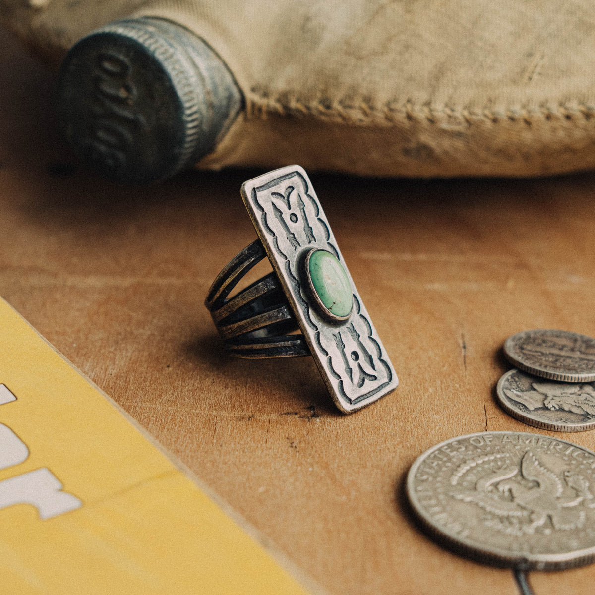 A hand-wrought sterling silver shield ring set with an oval Royston turquoise stone, its soft green face with subtle matrix, placed in a smooth straight bezel — view 2