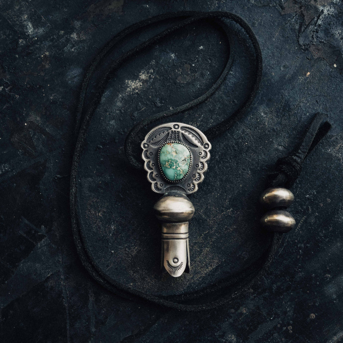 A hand-wrought sterling silver squash blossom pendant centered on a natural Fox turquoise stone, its green face veined with soft matrix and set in a hand-cut serrated bezel — view 3