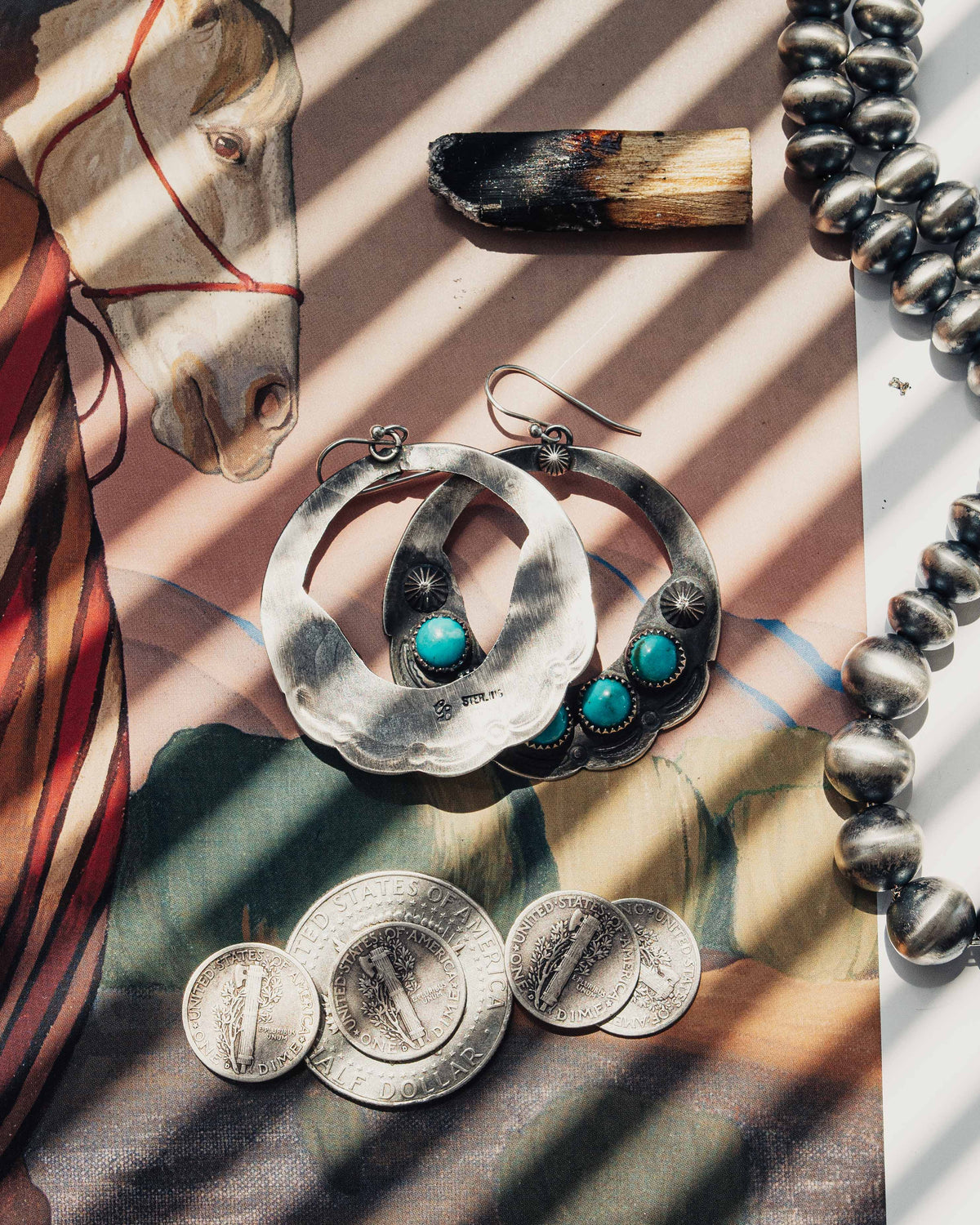 A pair of open-hoop earrings, each featuring five Carico Lake turquoise stones set in serrated bezels — view 2