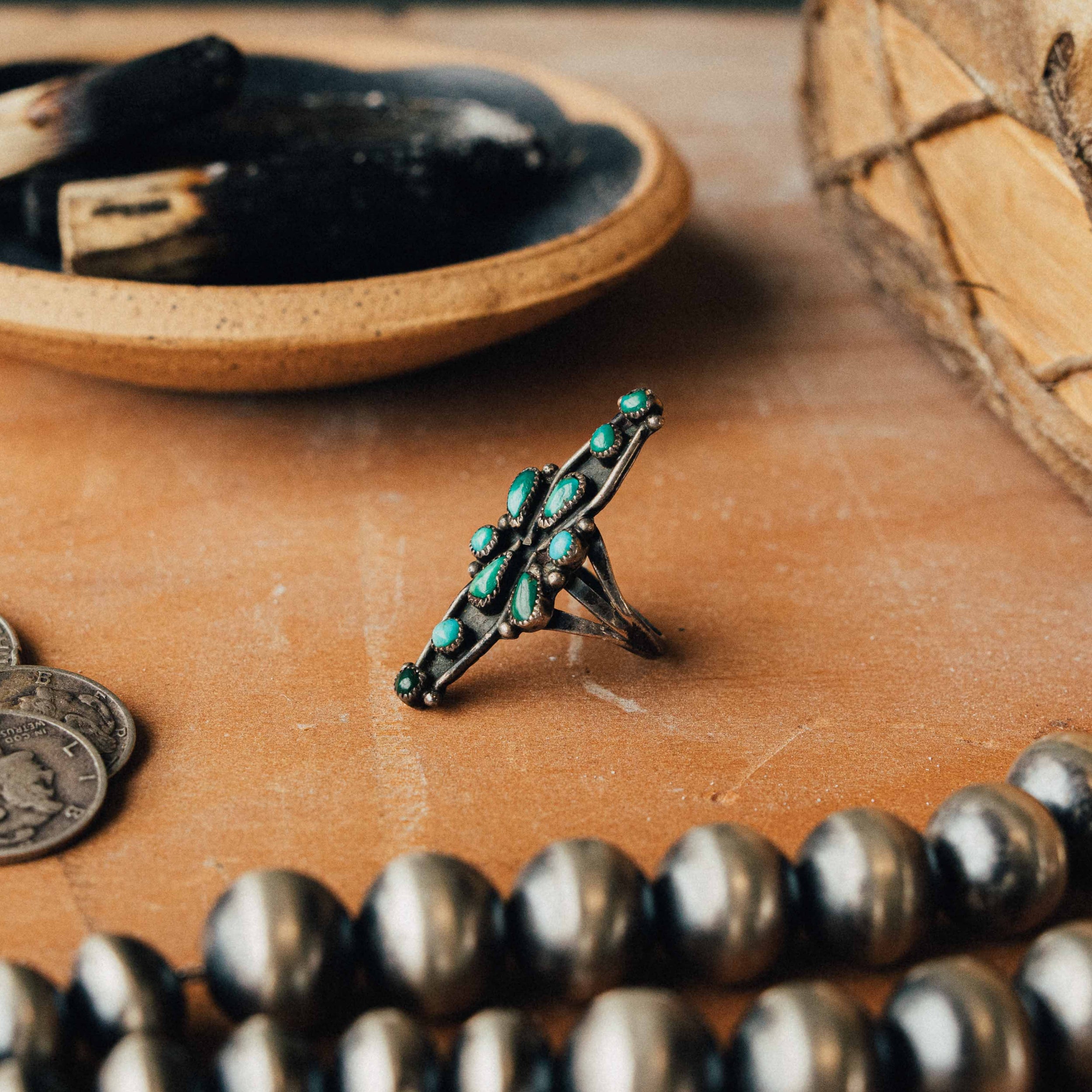A vintage Zuni snake-eye ring — mixed turquoise cluster in serrated bezels on a split shank, size 5.25 — view 2