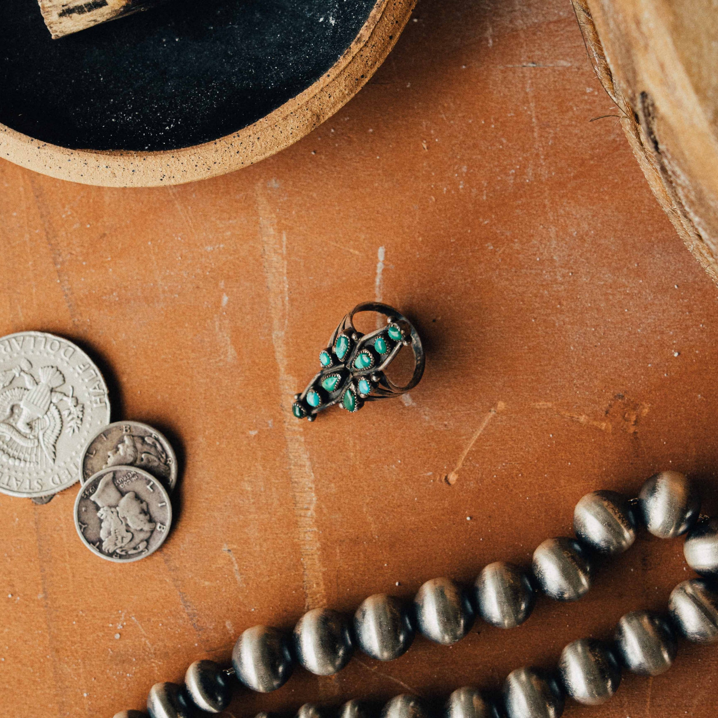 A vintage Zuni snake-eye ring — mixed turquoise cluster in serrated bezels on a split shank, size 5.25 — view 3