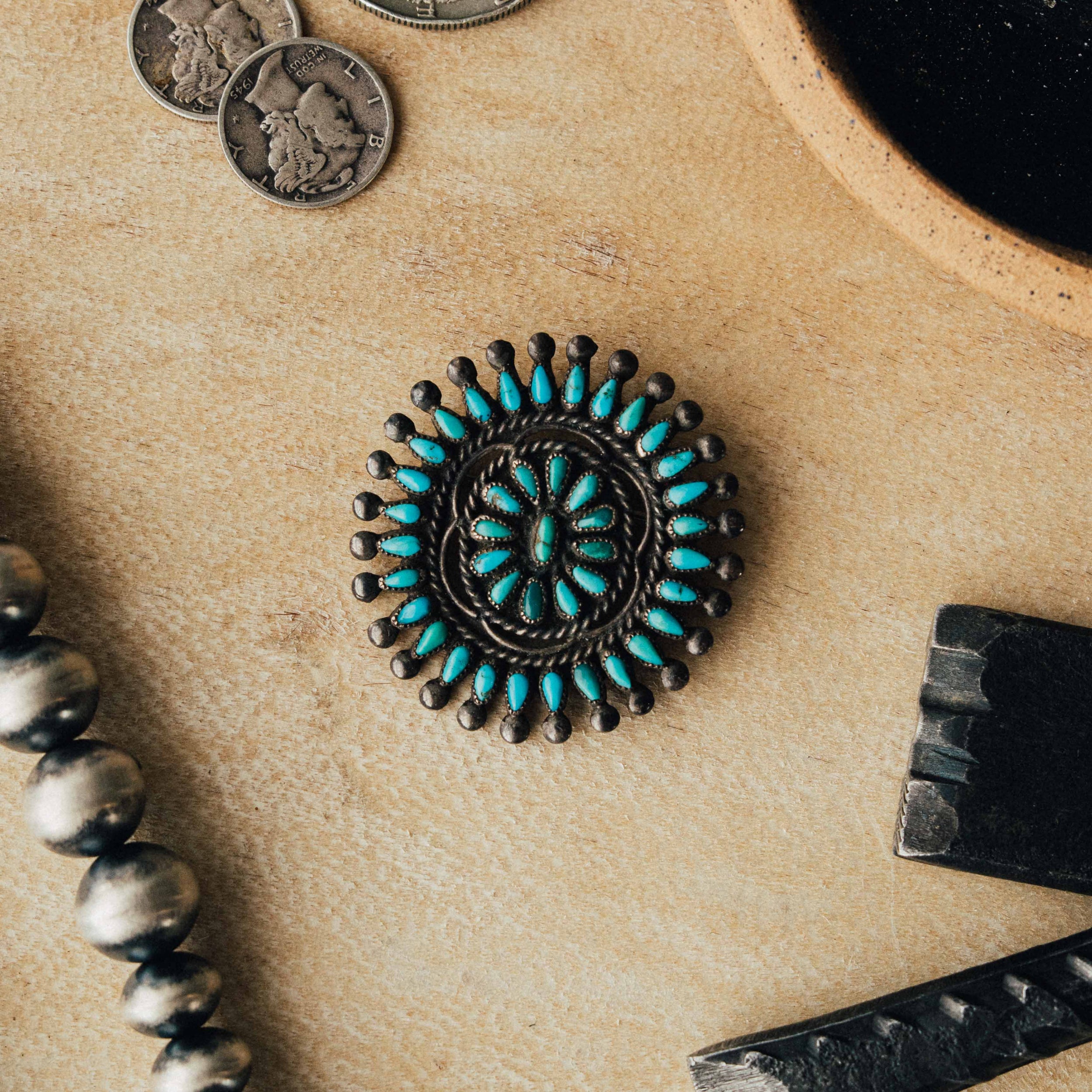 A vintage Zuni cluster pin — mixed high-grade turquoise in serrated bezels with intricate soldering and a strong natural patina — view 3