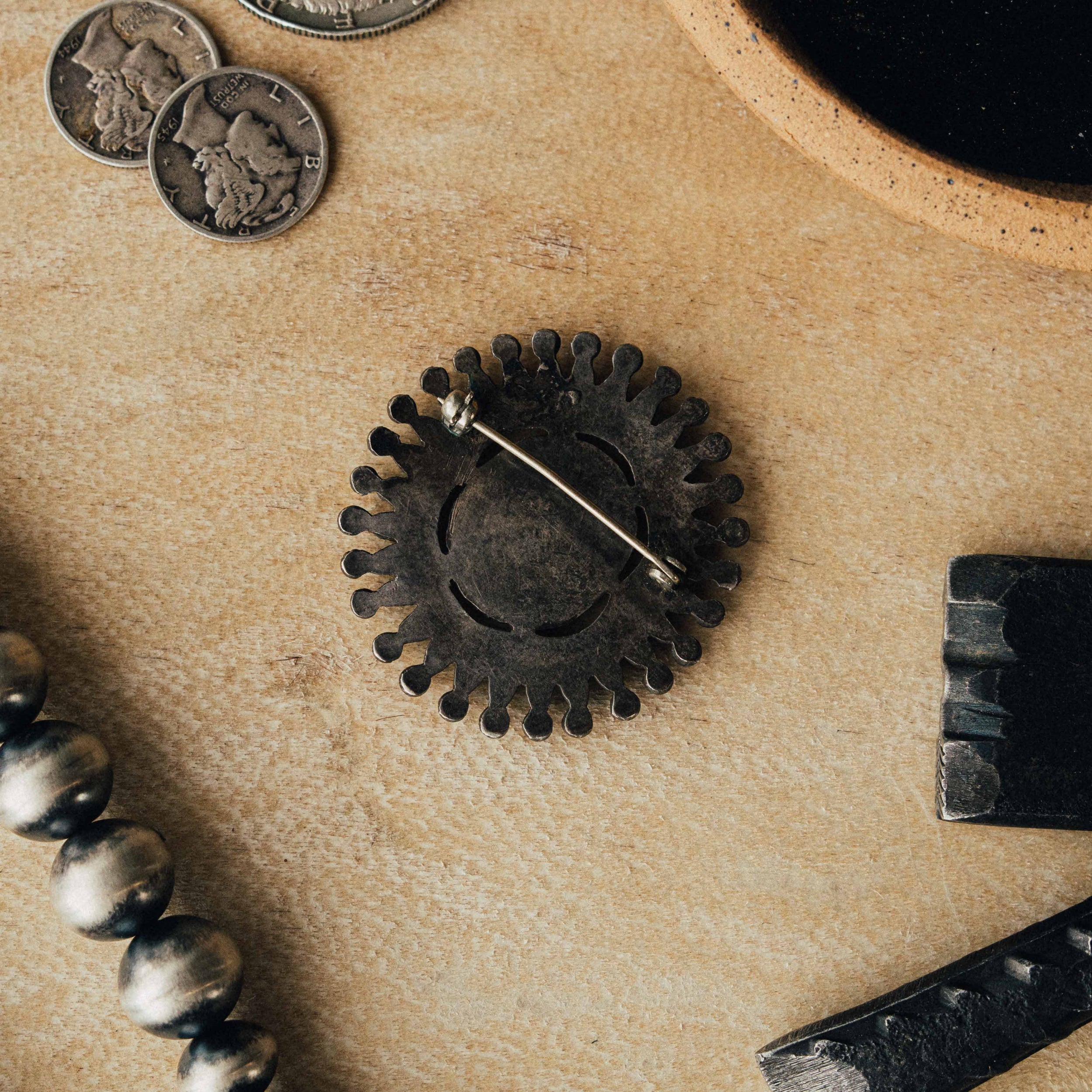 A vintage Zuni cluster pin — mixed high-grade turquoise in serrated bezels with intricate soldering and a strong natural patina — view 2