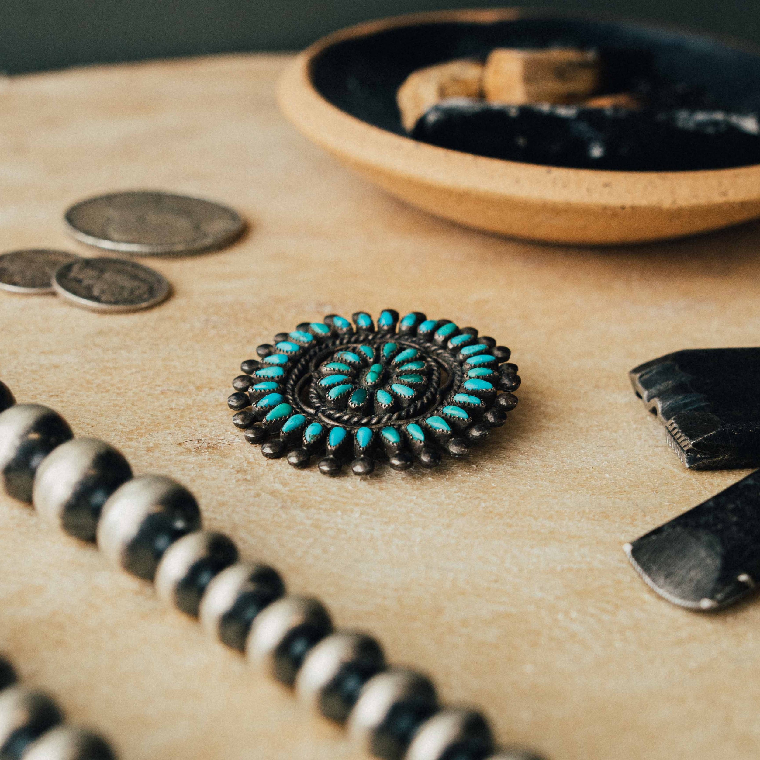 A vintage Zuni cluster pin — mixed high-grade turquoise in serrated bezels with intricate soldering and a strong natural patina — view 4