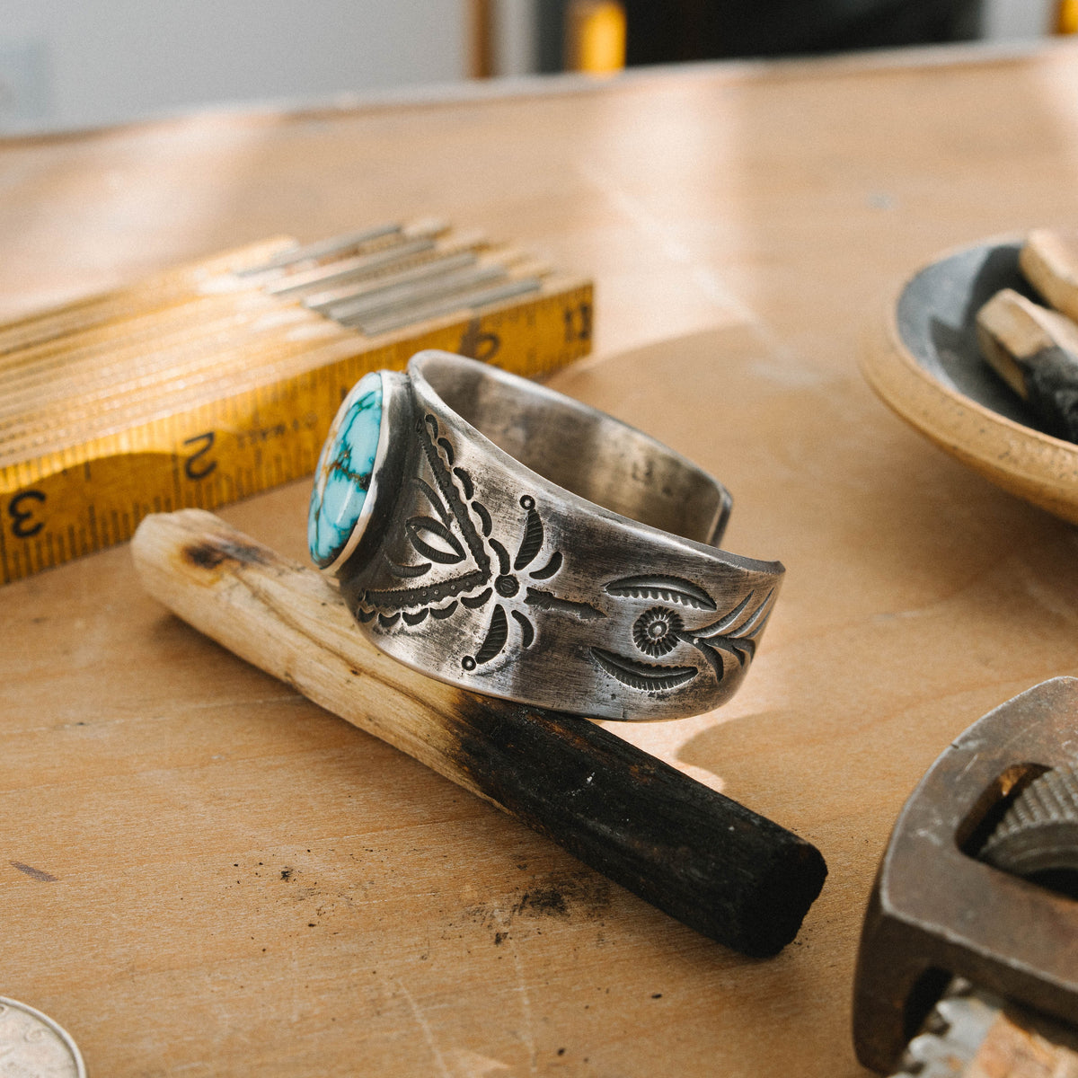 A tufa cast ingot cuff stamped with a set of our one-of-a-kind steel stamps set with a high grade Kingman Water Web turquoise stone One of a kind, now held in a private collection — view 2