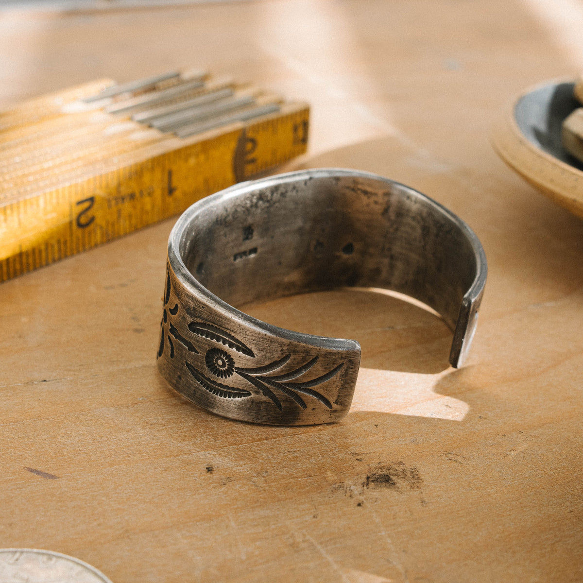 A tufa cast ingot cuff stamped with a set of our one-of-a-kind steel stamps set with a high grade Kingman Water Web turquoise stone One of a kind, now held in a private collection — view 3
