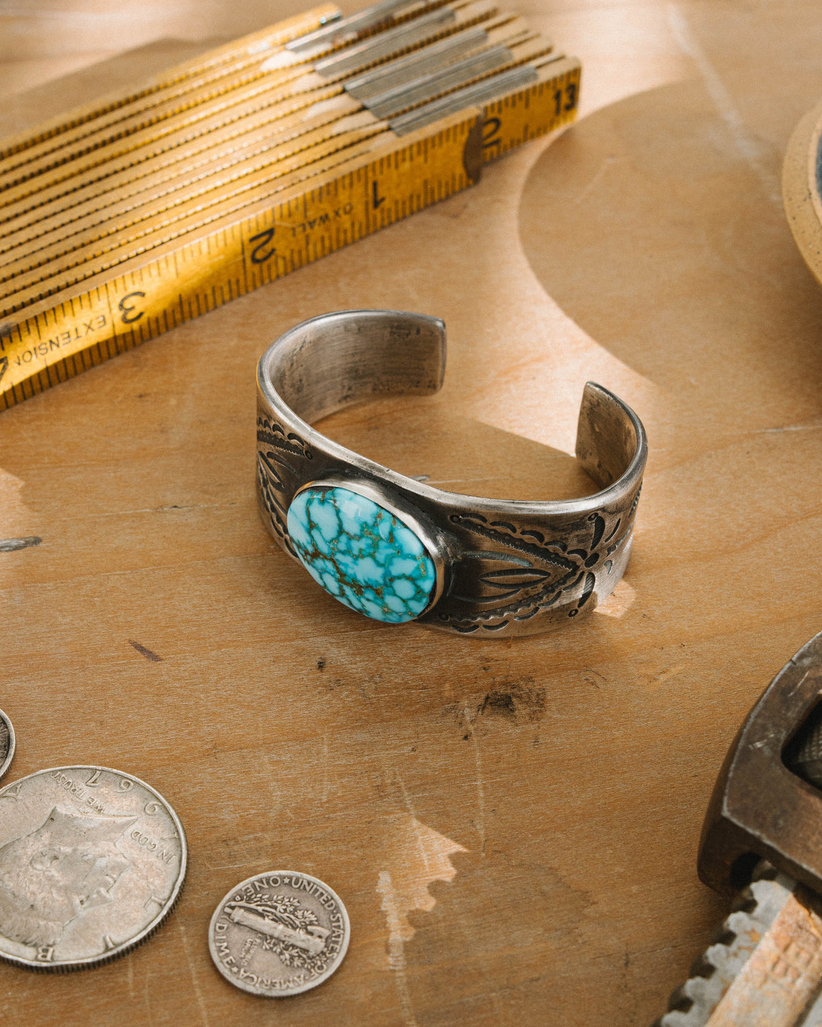 A tufa cast ingot cuff stamped with a set of our one-of-a-kind steel stamps set with a high grade Kingman Water Web turquoise stone One of a kind, now held in a private collection — view 4