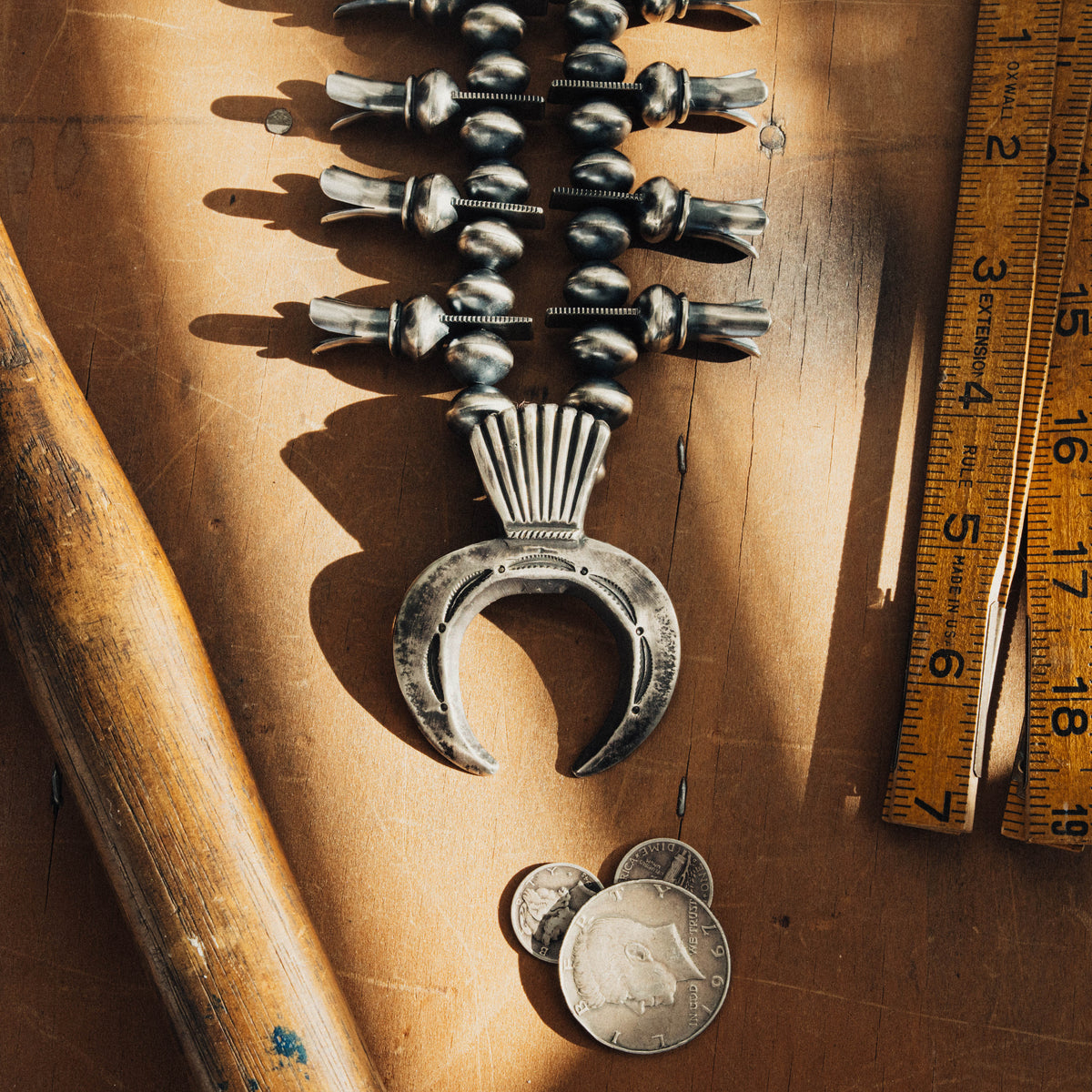 A traditional sterling silver squash blossom necklace, strung with substantial oxidized silver beads — view 3