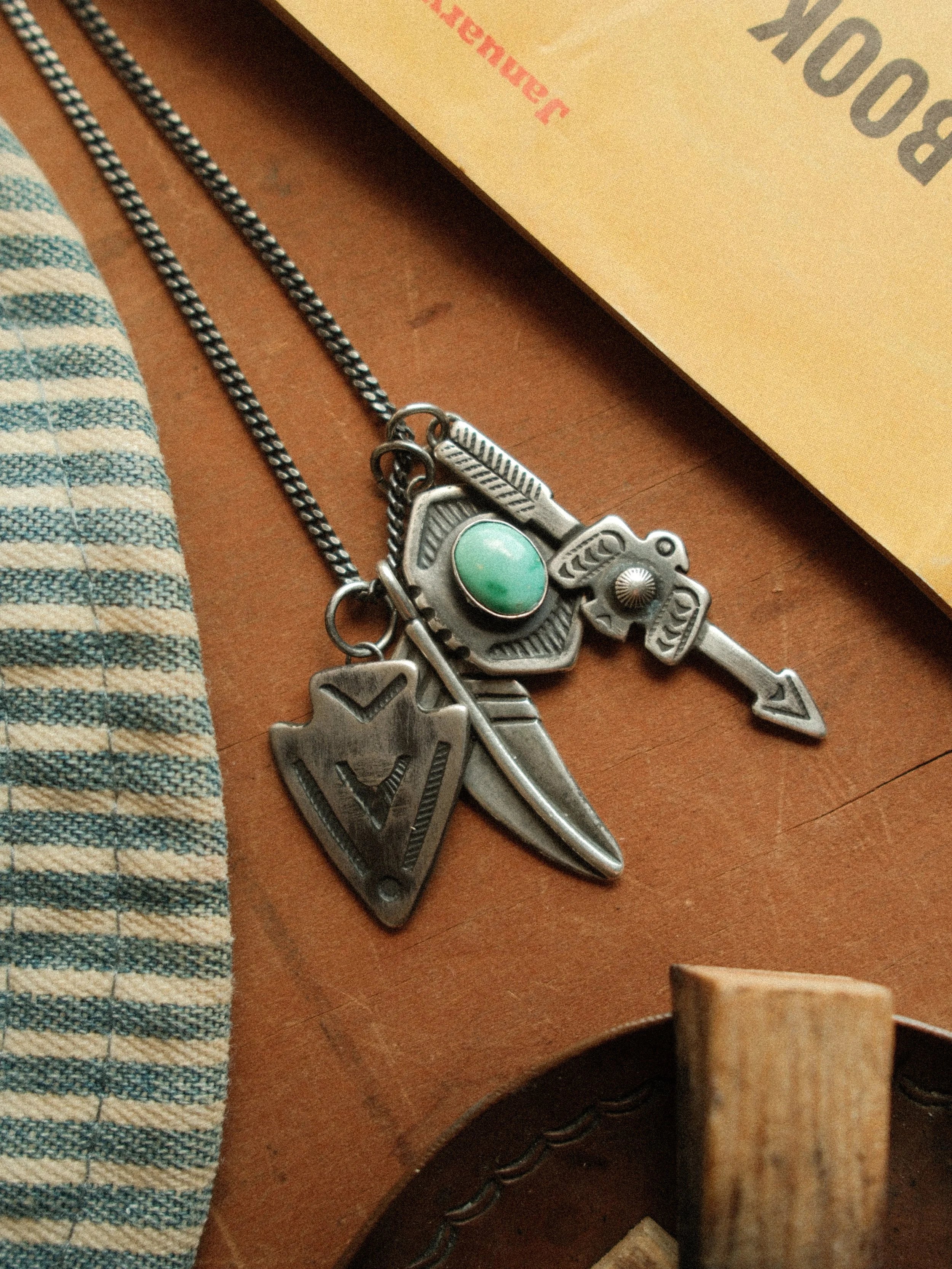 Arrow and thunderbird joined in fine sterling stampwork, centered with Carico Lake turquoise or a silver concho — view 8