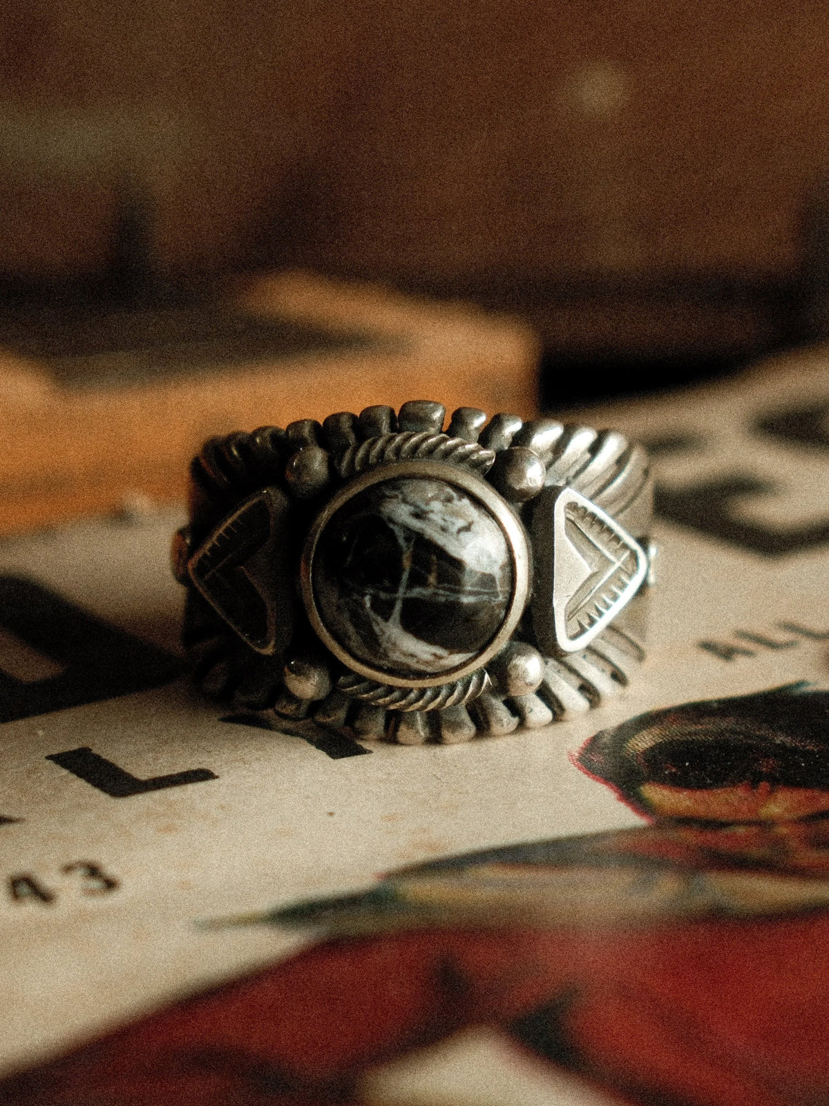 A premium 10mm White Buffalo stone on a heavy sterling Chief ring with hand-struck side detailing.