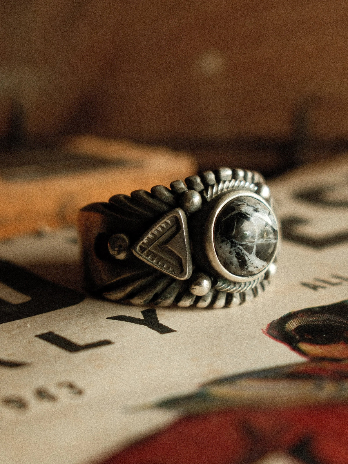 A premium 10mm White Buffalo stone on a heavy sterling Chief ring with hand-struck side detailing. — view 4