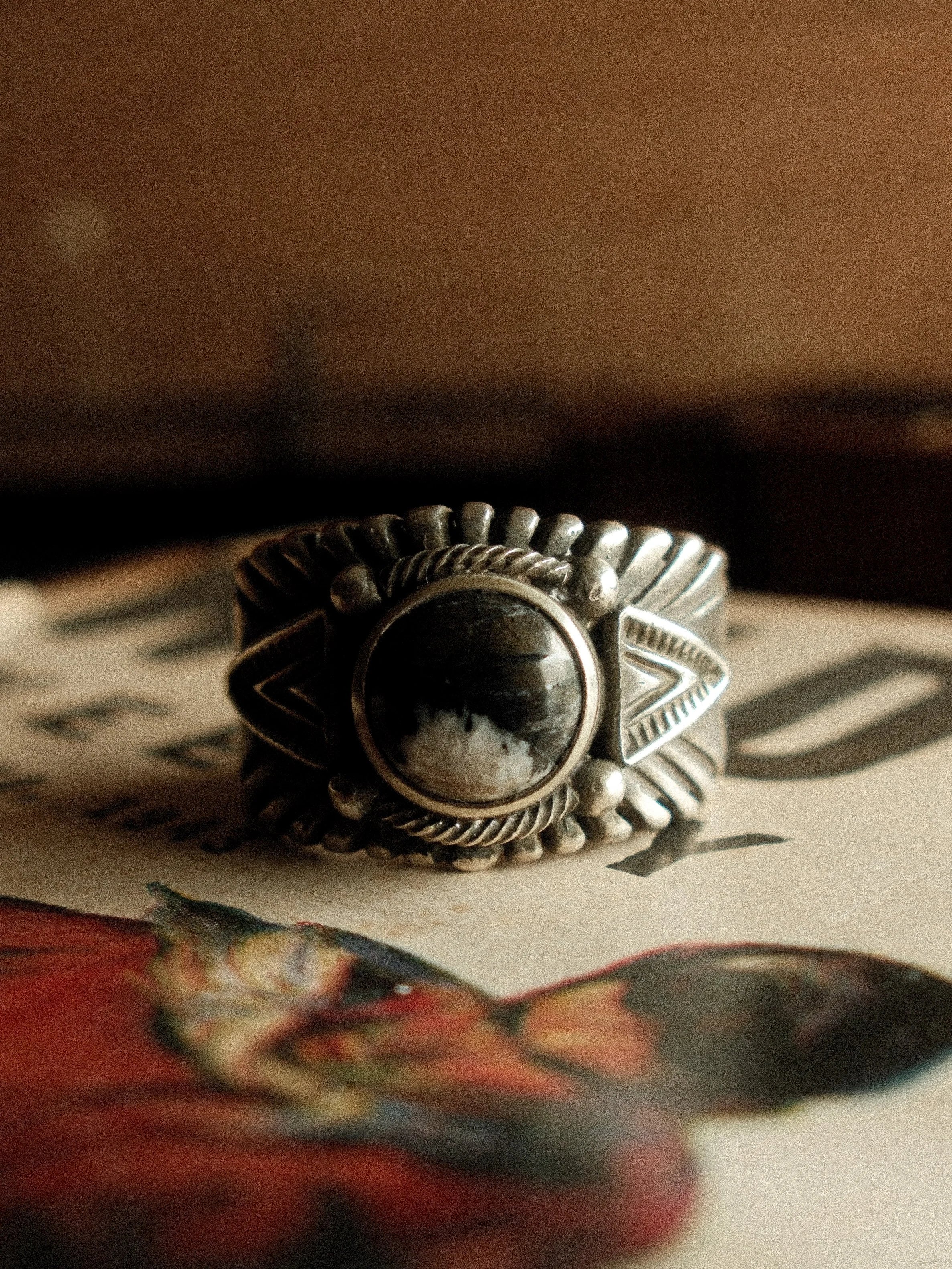 A frontier-heirloom Chief ring — premium White Buffalo stone, hand-struck detailing, substantial sterling weight