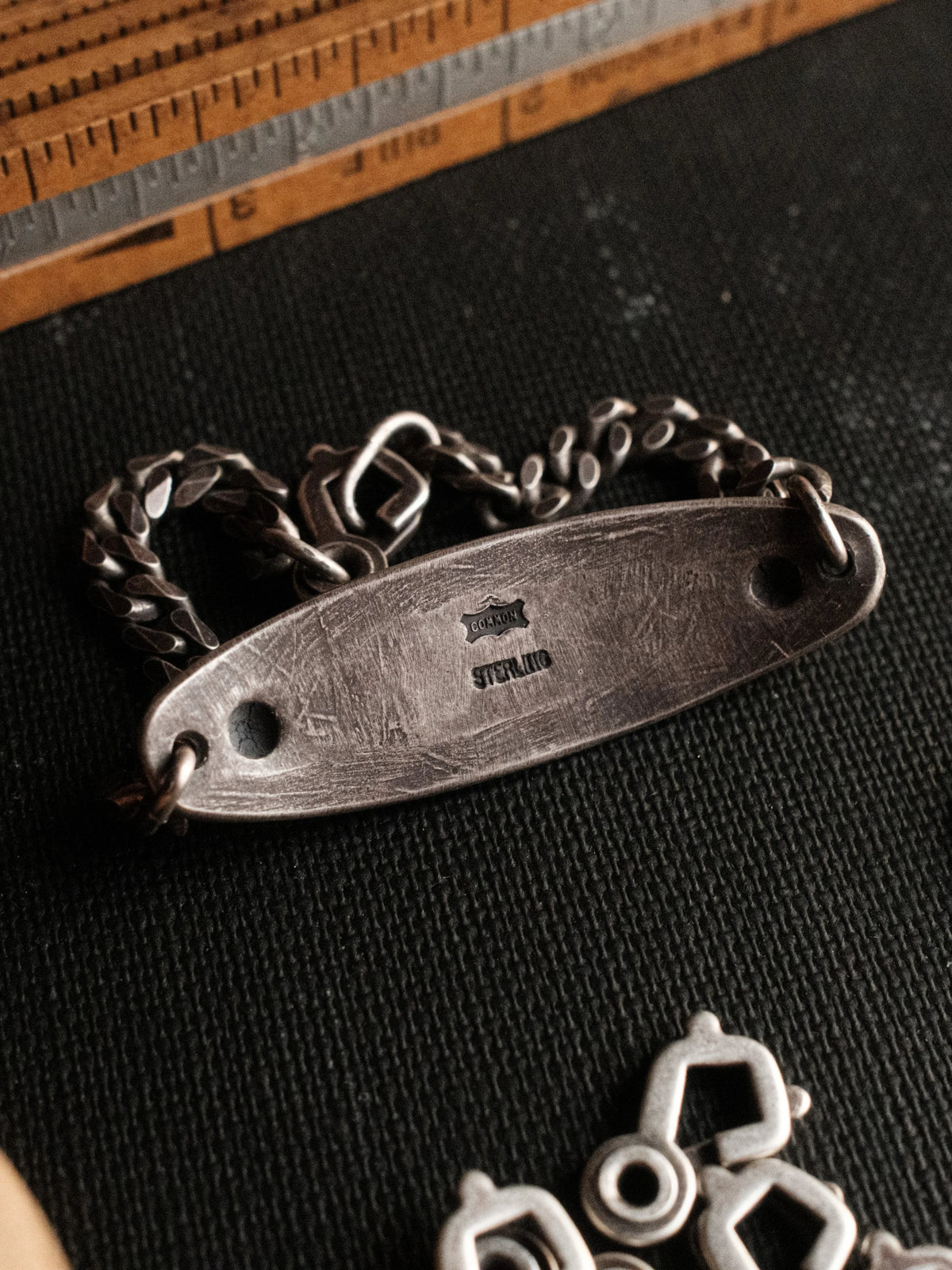 A hand-stamped ID plate set with Manassa turquoise on a sterling chain with a sister-hook clasp, finished in an aged patina — view 2