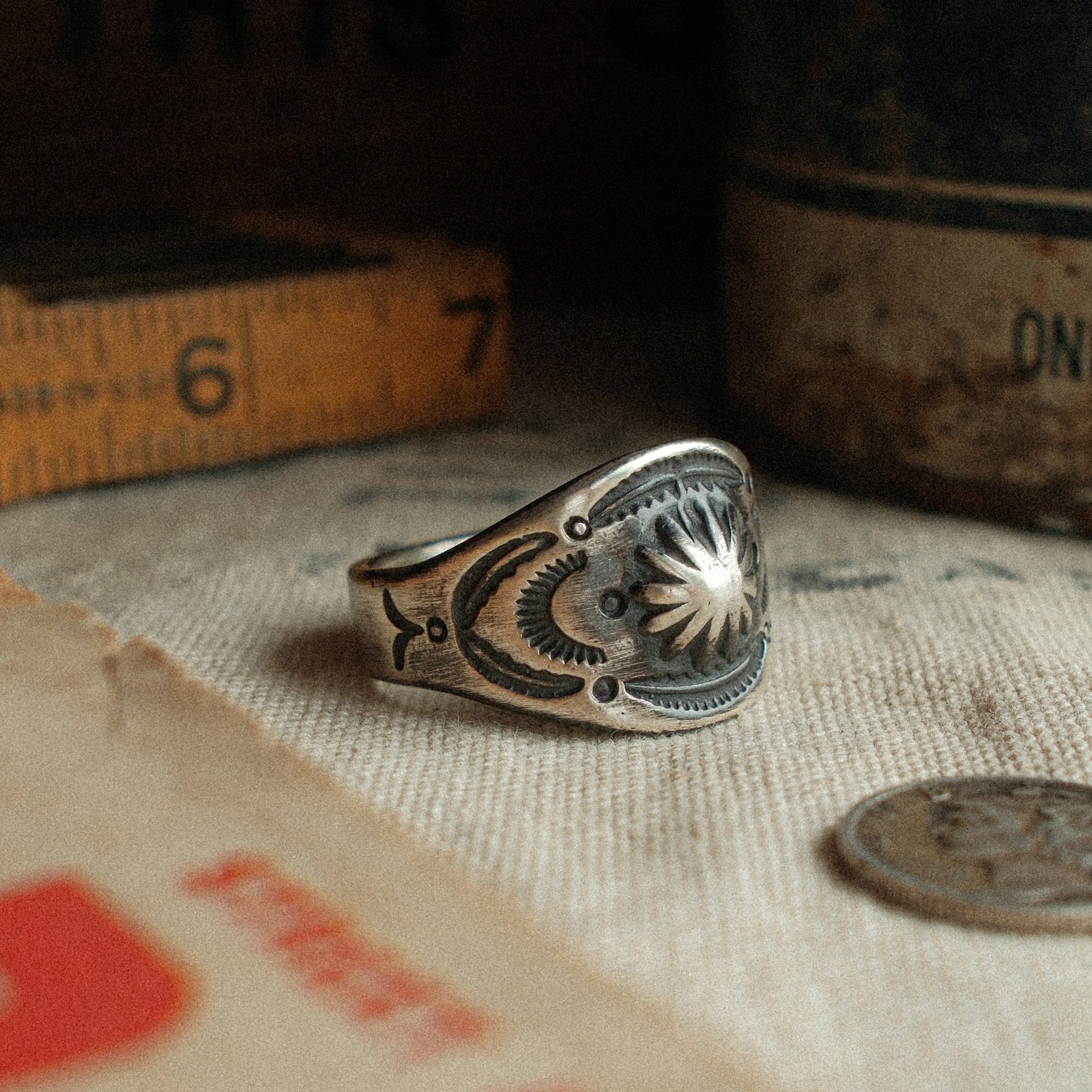 A vintage-inspired sterling cigar-band ring, hand-stamped with a 17mm top width and strong patina. Made to your size.