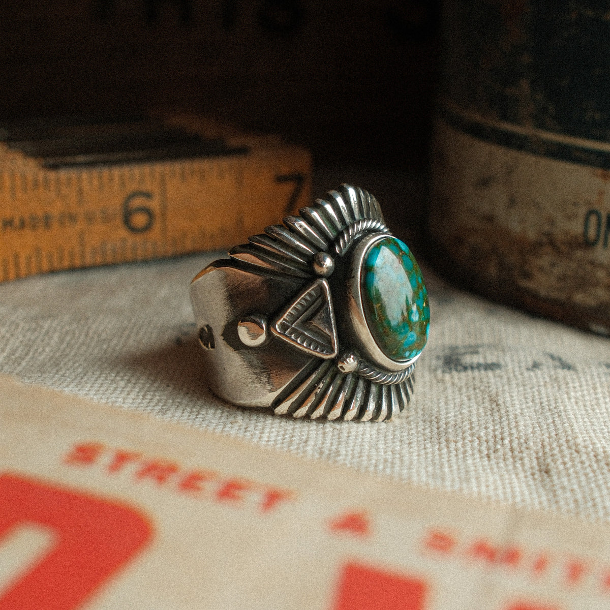 A high-grade Kingman Water Web turquoise cabochon set in a smooth bezel, framed by hand-stamped rays that fan out like a headdress — view 2