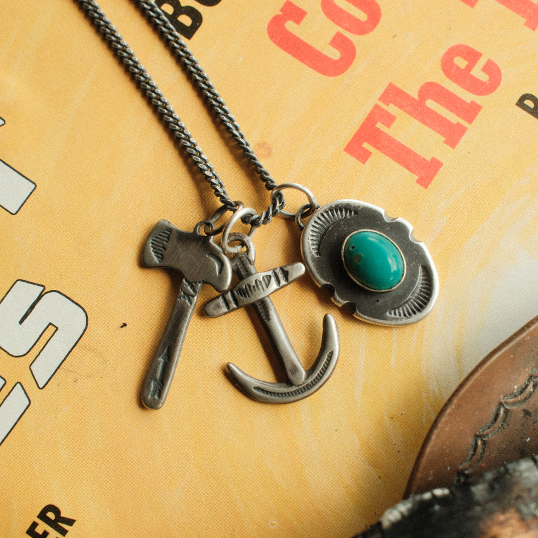 An oval sterling silver shield pendant with notched sides, set with sea-green Carico Lake turquoise — view 4