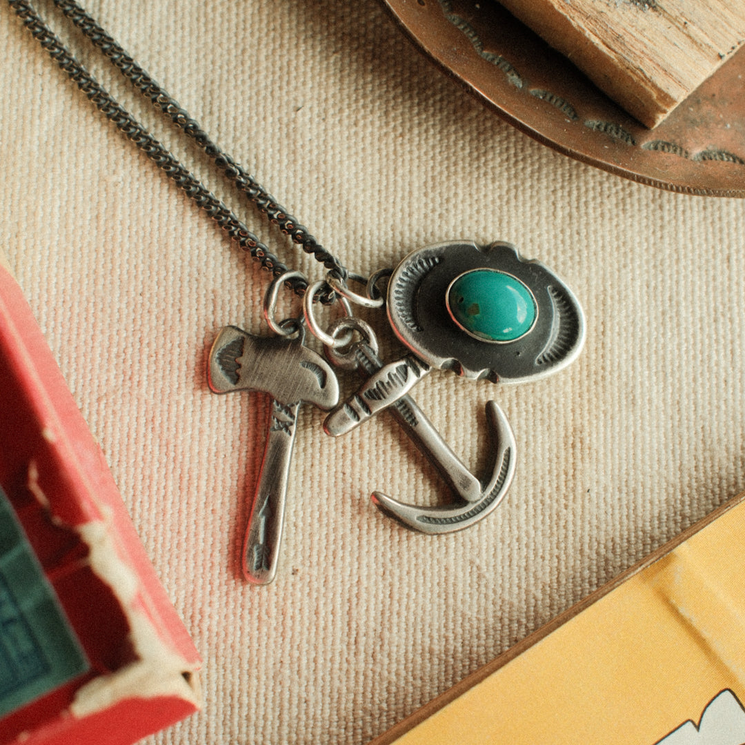 An oval sterling silver shield pendant with notched sides, set with sea-green Carico Lake turquoise — view 2