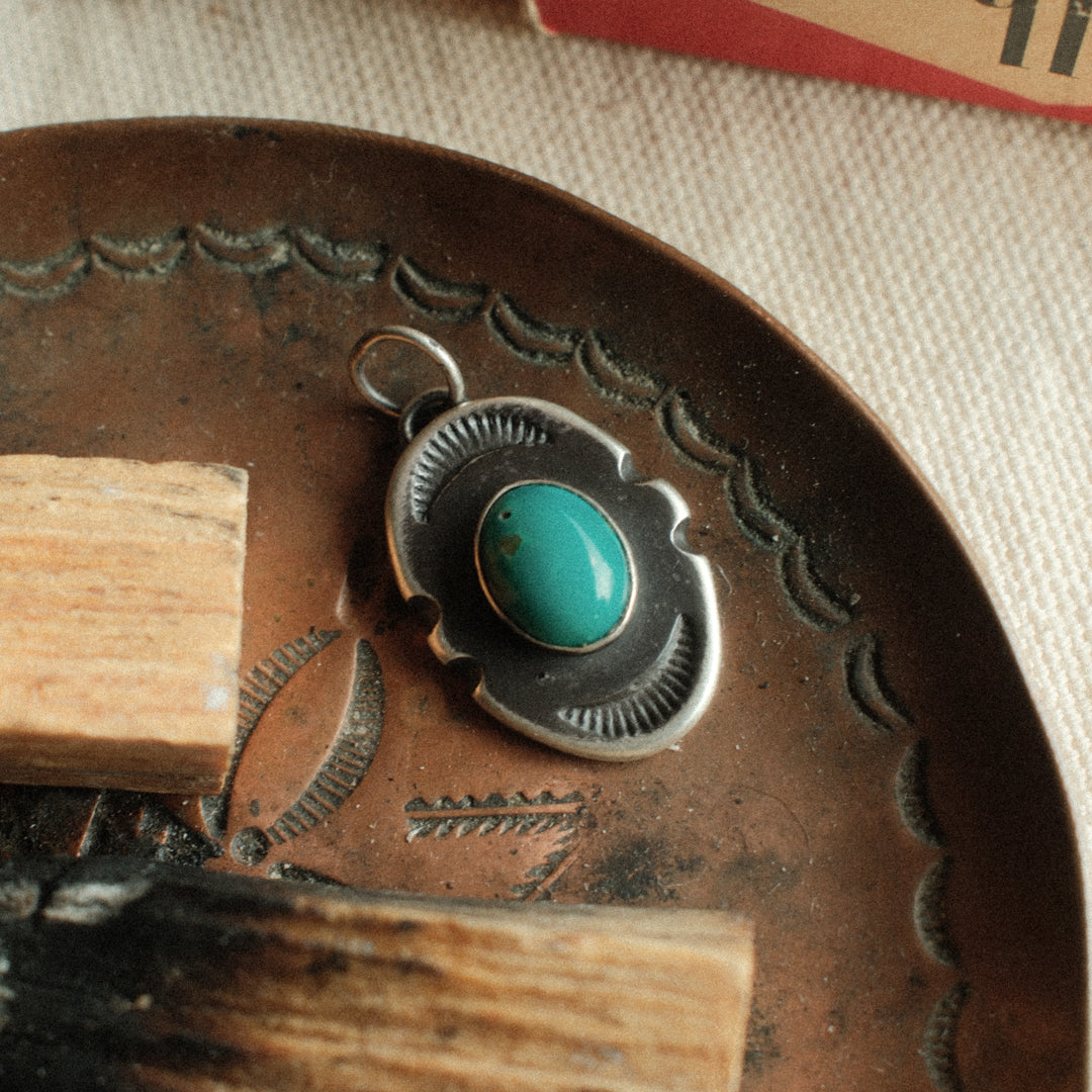 An oval sterling silver shield pendant with notched sides, set with sea-green Carico Lake turquoise — view 6