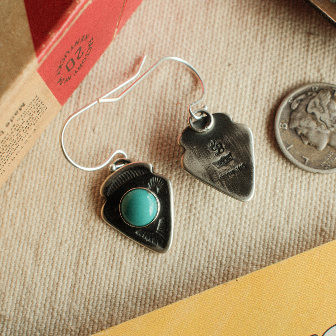 A pair of sterling silver arrowhead earrings with Lone Mountain turquoise centers and a well-worn patina — view 2