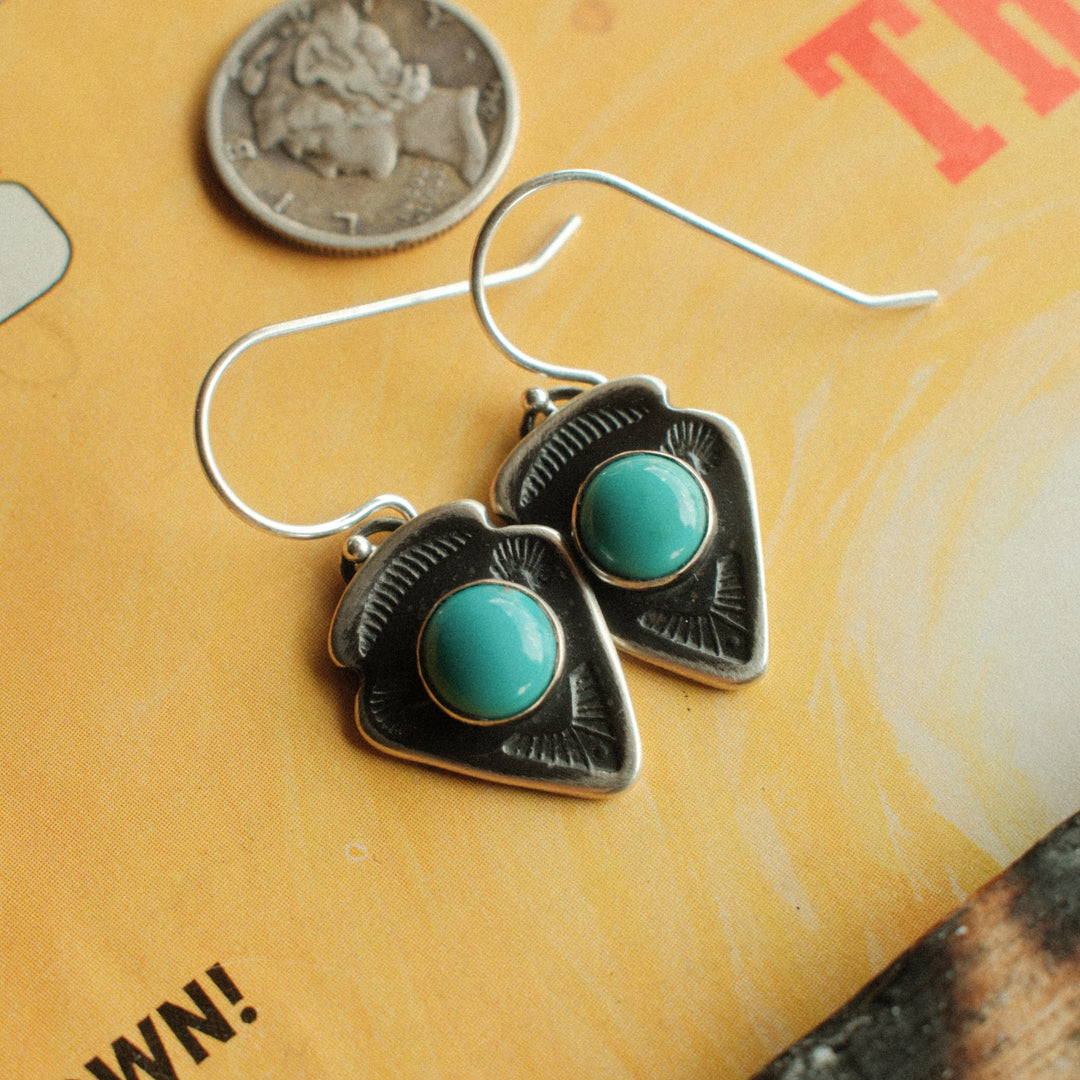 A pair of sterling silver arrowhead earrings with Lone Mountain turquoise centers and a well-worn patina — view 3