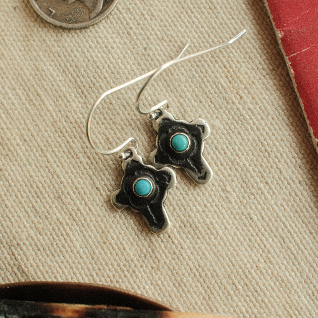 Traditional sterling silver cross earrings on French wires with a dark patina, set with Lone Mountain turquoise in blue and Tyrone in green.