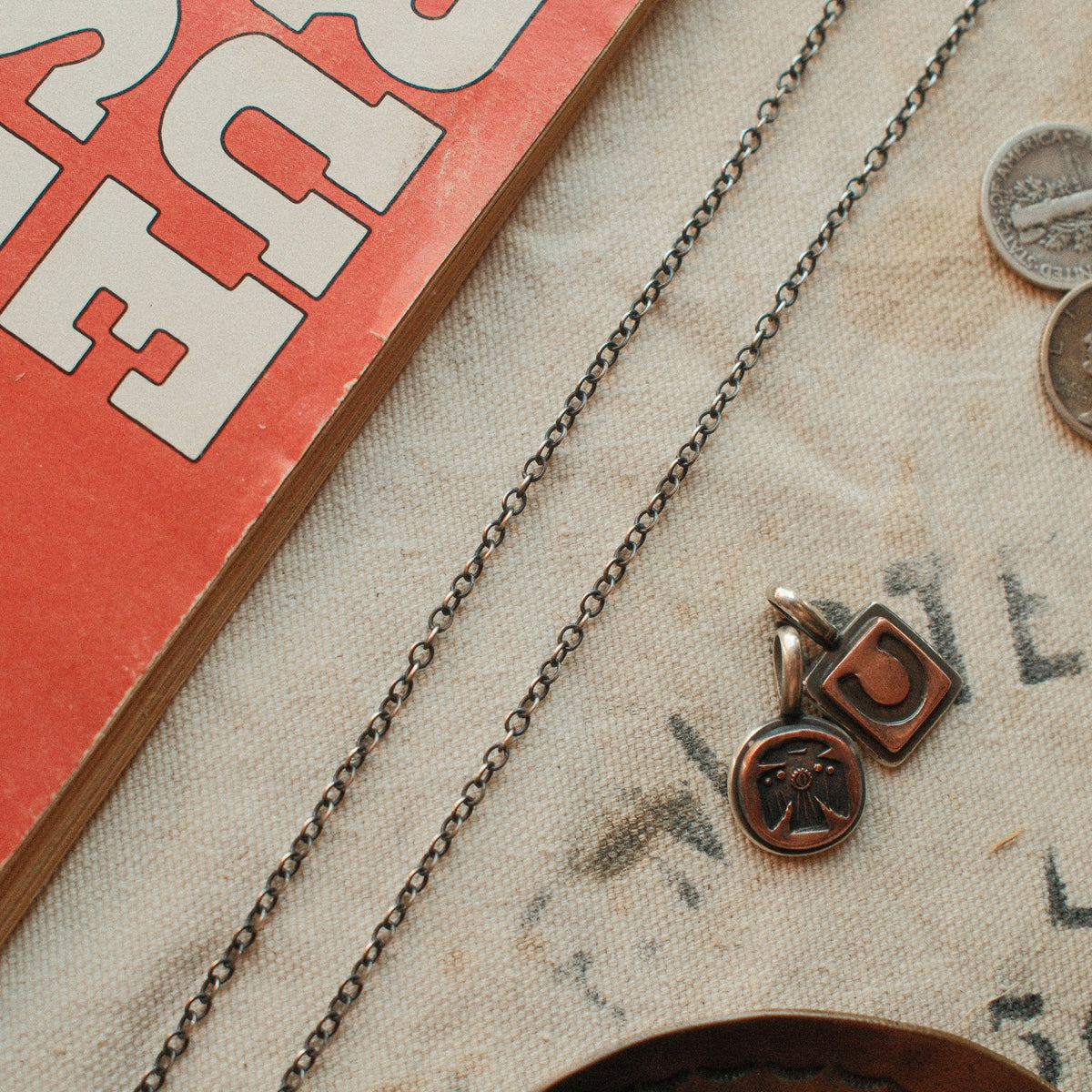A 2.4mm sterling silver cable chain in 20 to 30 inch lengths, hand-finished with a strong patina and closed with a lobster clasp.