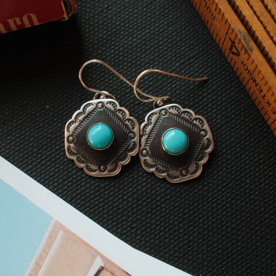 Vintage-inspired sterling silver earrings with scalloped corners, set with Lone Mountain turquoise and finished with a strong patina. — view 3