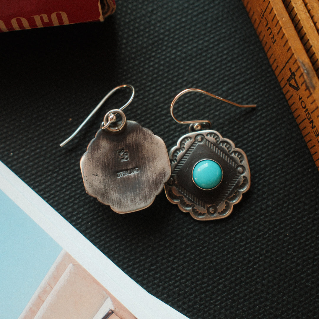 Vintage-inspired sterling silver earrings with scalloped corners, set with Lone Mountain turquoise and finished with a strong patina. — view 4
