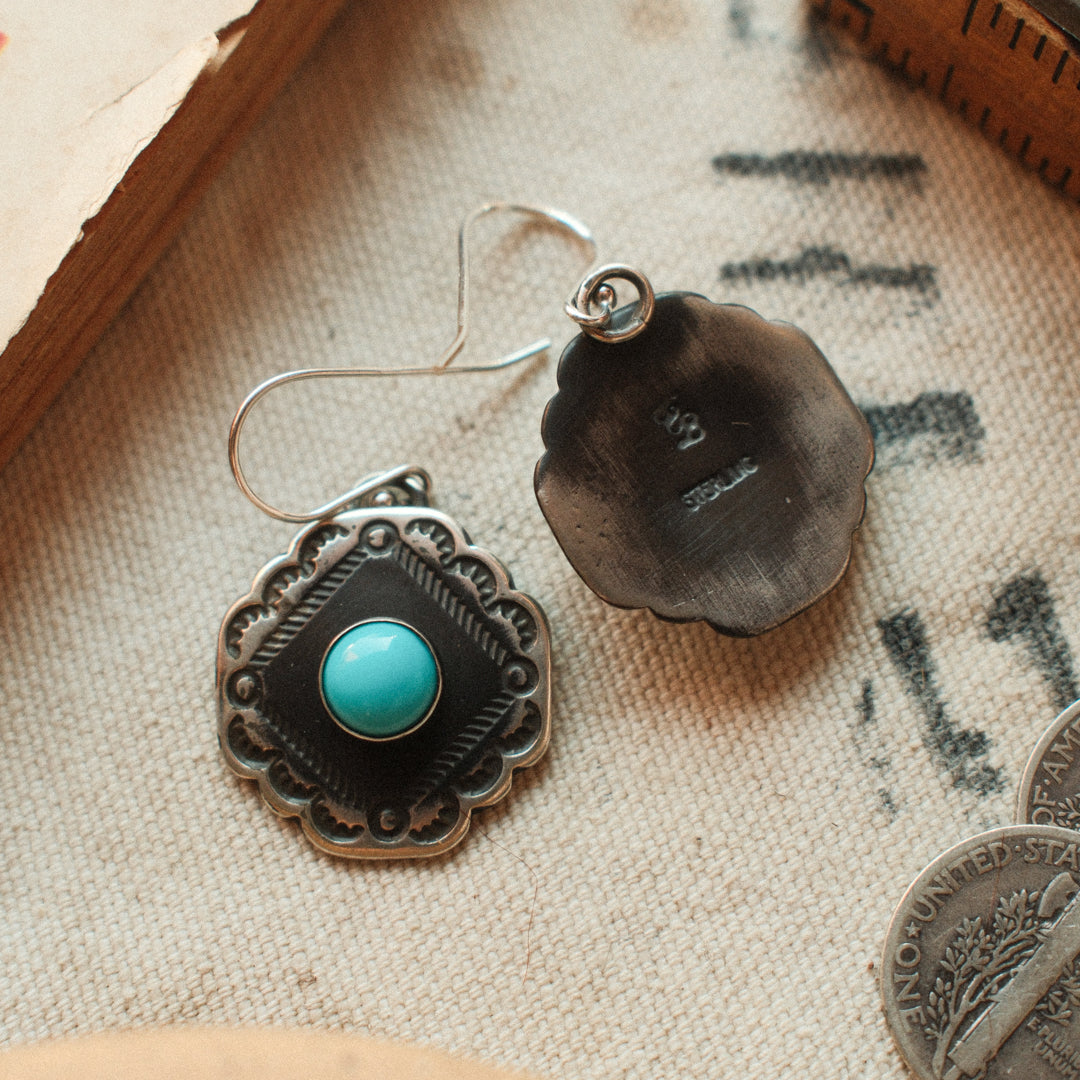 Vintage-inspired sterling silver earrings with scalloped corners, set with Lone Mountain turquoise and finished with a strong patina. — view 2