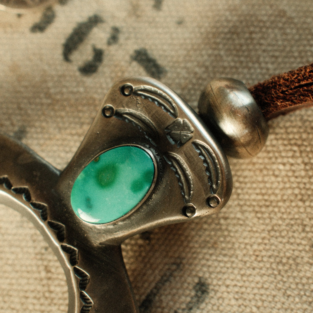 A one-of-a-kind tufa-cast Naja, thunderbird-stamped and set with a 9×15mm premium piece of Fox turquoise, on brown leather with two handmade silver adjusting beads — view 3