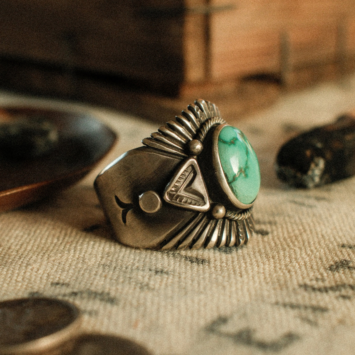 A Fox turquoise stone set in a smooth bezel inside a twisted rope border, framed by hand-stamped rays that fan out like a headdress — view 3