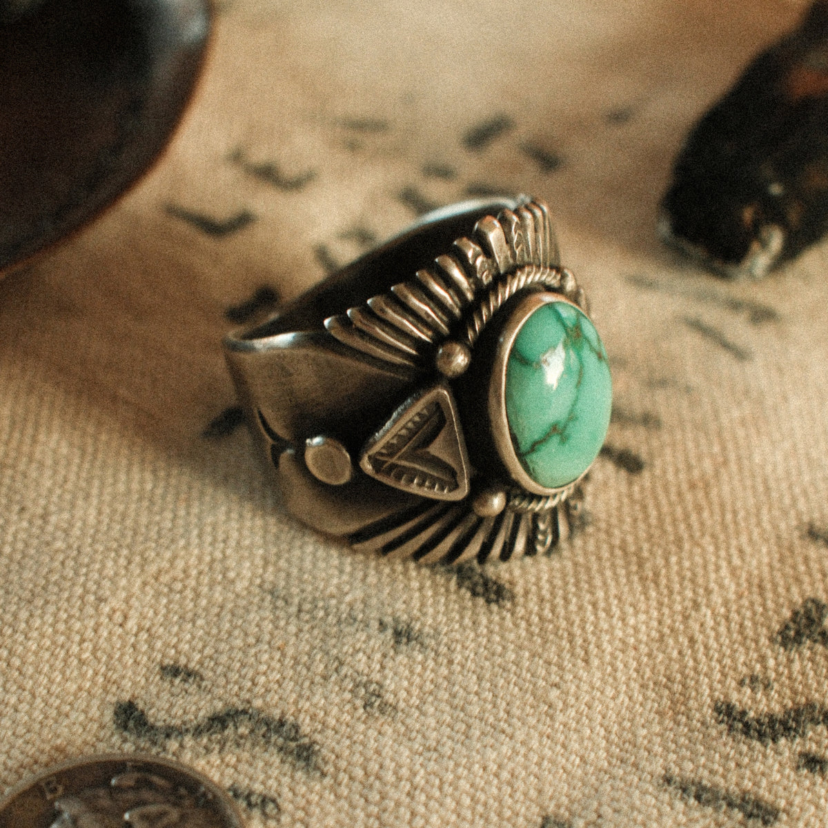 A Fox turquoise stone set in a smooth bezel inside a twisted rope border, framed by hand-stamped rays that fan out like a headdress — view 2