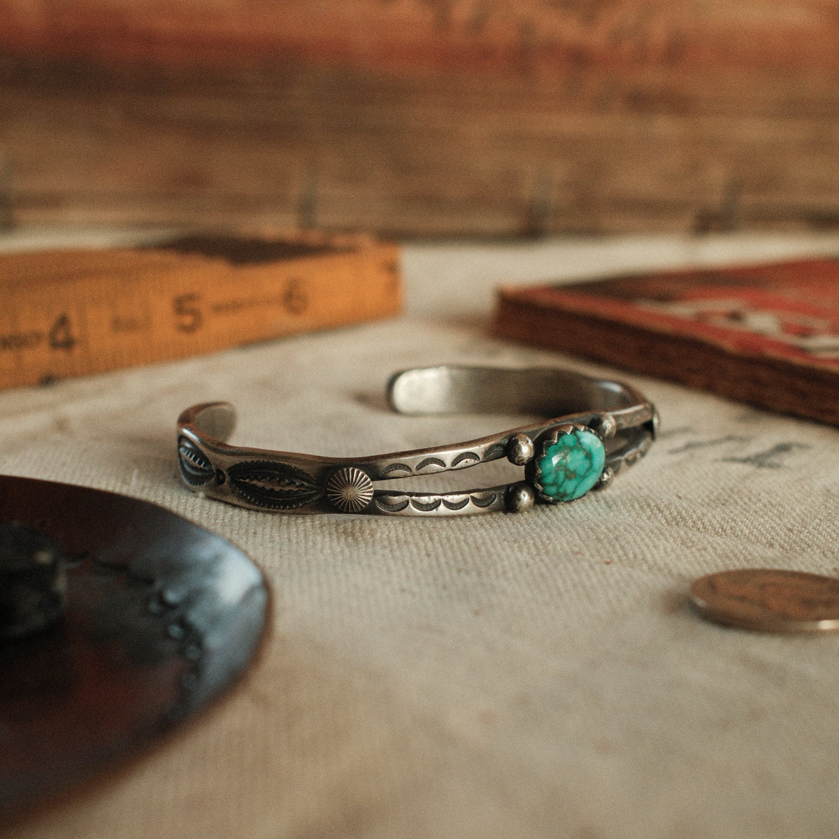 A one-of-a-kind tufa-cast split cuff with an 8×12mm Fox turquoise in a hand filed serrated bezel, between silver beads on twin bars — view 2