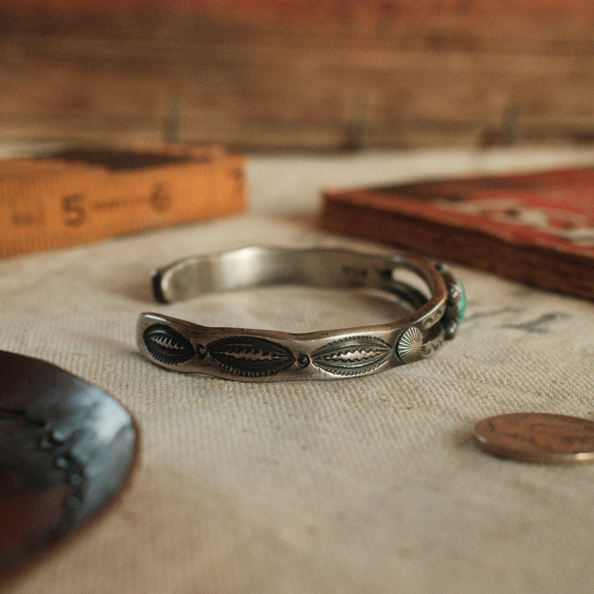 A one-of-a-kind tufa-cast split cuff with an 8×12mm Fox turquoise in a hand filed serrated bezel, between silver beads on twin bars — view 5