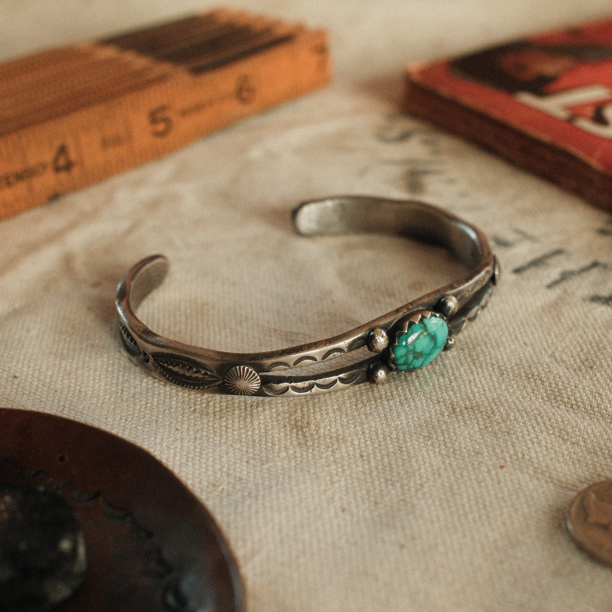 A one-of-a-kind tufa-cast split cuff with an 8×12mm Fox turquoise in a hand filed serrated bezel, between silver beads on twin bars — view 4