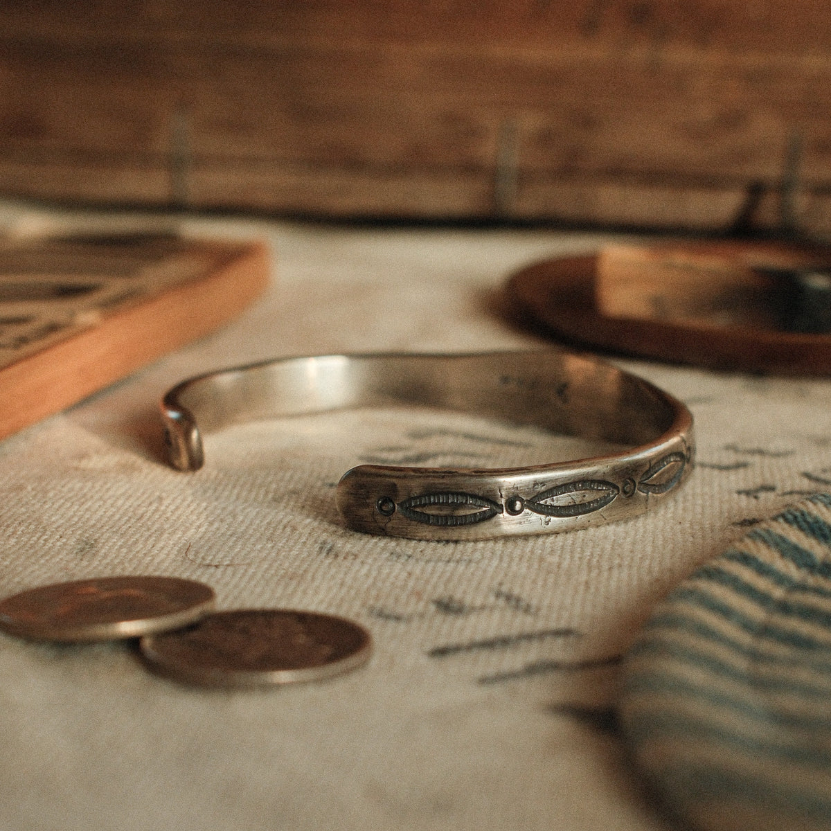 A one-of-a-kind tufa-cast stacking cuff with a 7×9mm Fox turquoise in a hand filed serrated bezel between stamped arrowhead panels — view 5