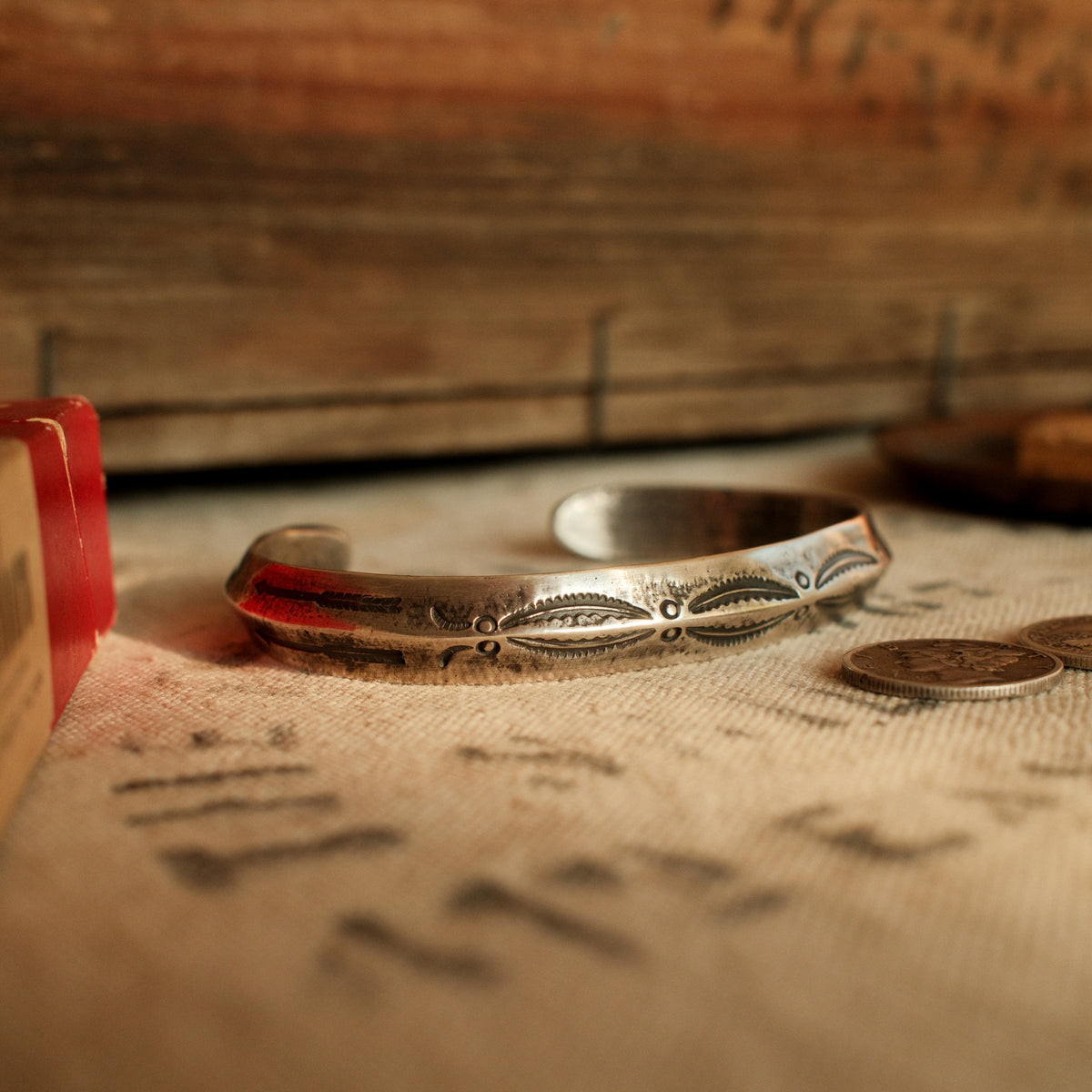A one-of-a-kind triangular cuff forged from a tufa-cast sterling ingot with the casting texture intact, deeply stamped with arrows at each terminal — view 5