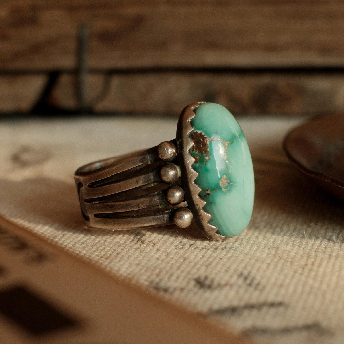 A one-of-a-kind high-domed 12×20mm Fox turquoise in a hand filed serrated bezel on a four-prong split shank, stamped on the back — view 2