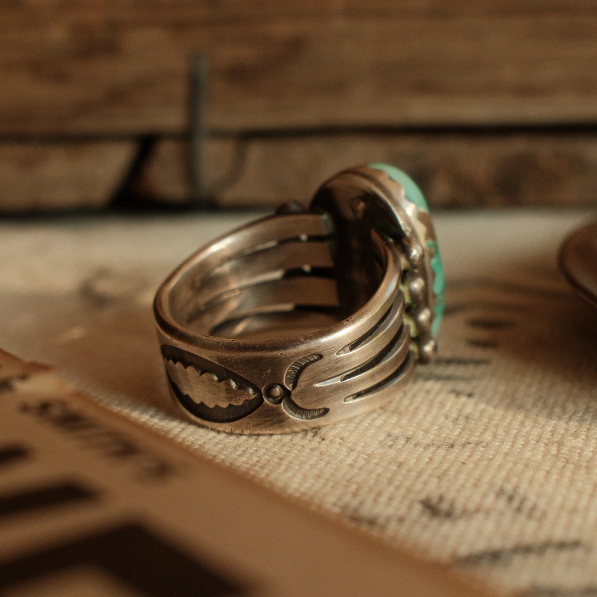 A one-of-a-kind high-domed 12×20mm Fox turquoise in a hand filed serrated bezel on a four-prong split shank, stamped on the back — view 3