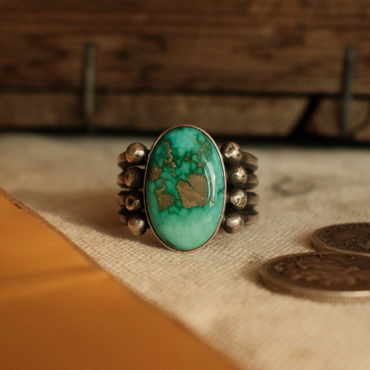 A one-of-a-kind 10×16mm Fox turquoise in a smooth bezel on a four-prong split shank with stacked silver beads, arrowhead stamped on the back — view 2