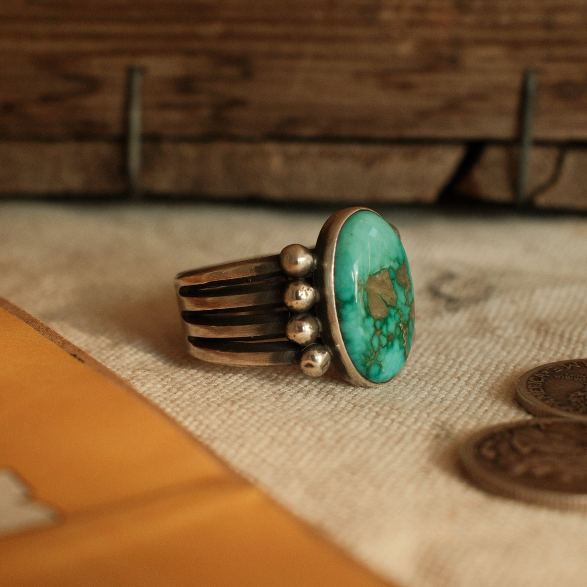 A one-of-a-kind 10×16mm Fox turquoise in a smooth bezel on a four-prong split shank with stacked silver beads, arrowhead stamped on the back — view 4