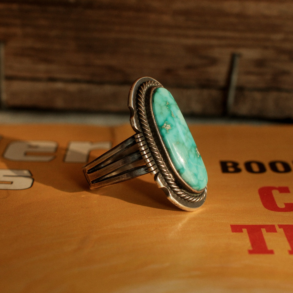 A one-of-a-kind 8×20mm Carico Lake turquoise in a straight bezel inside a twist wire border, on a three-prong stamped split shank — view 2