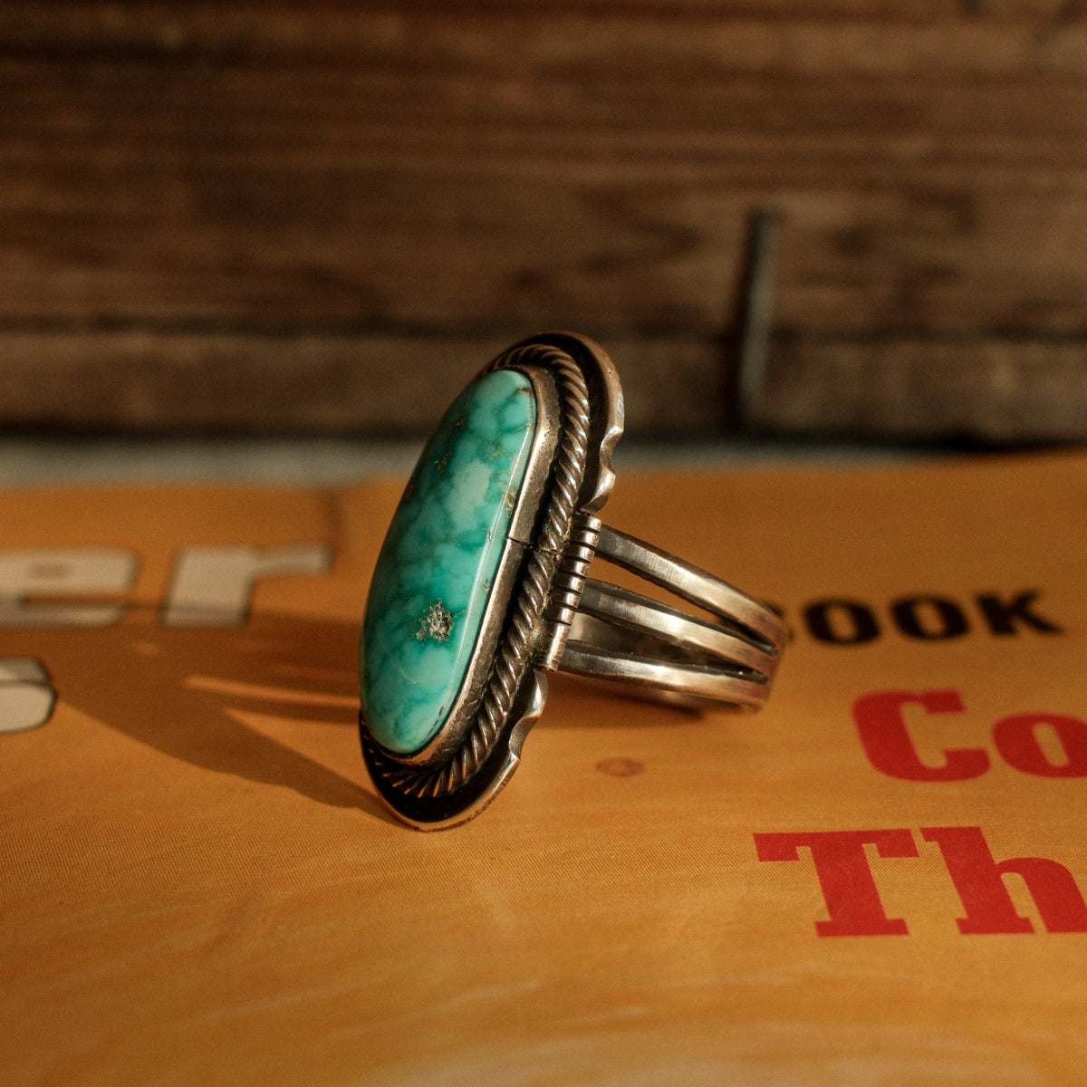 A one-of-a-kind 8×20mm Carico Lake turquoise in a straight bezel inside a twist wire border, on a three-prong stamped split shank — view 3
